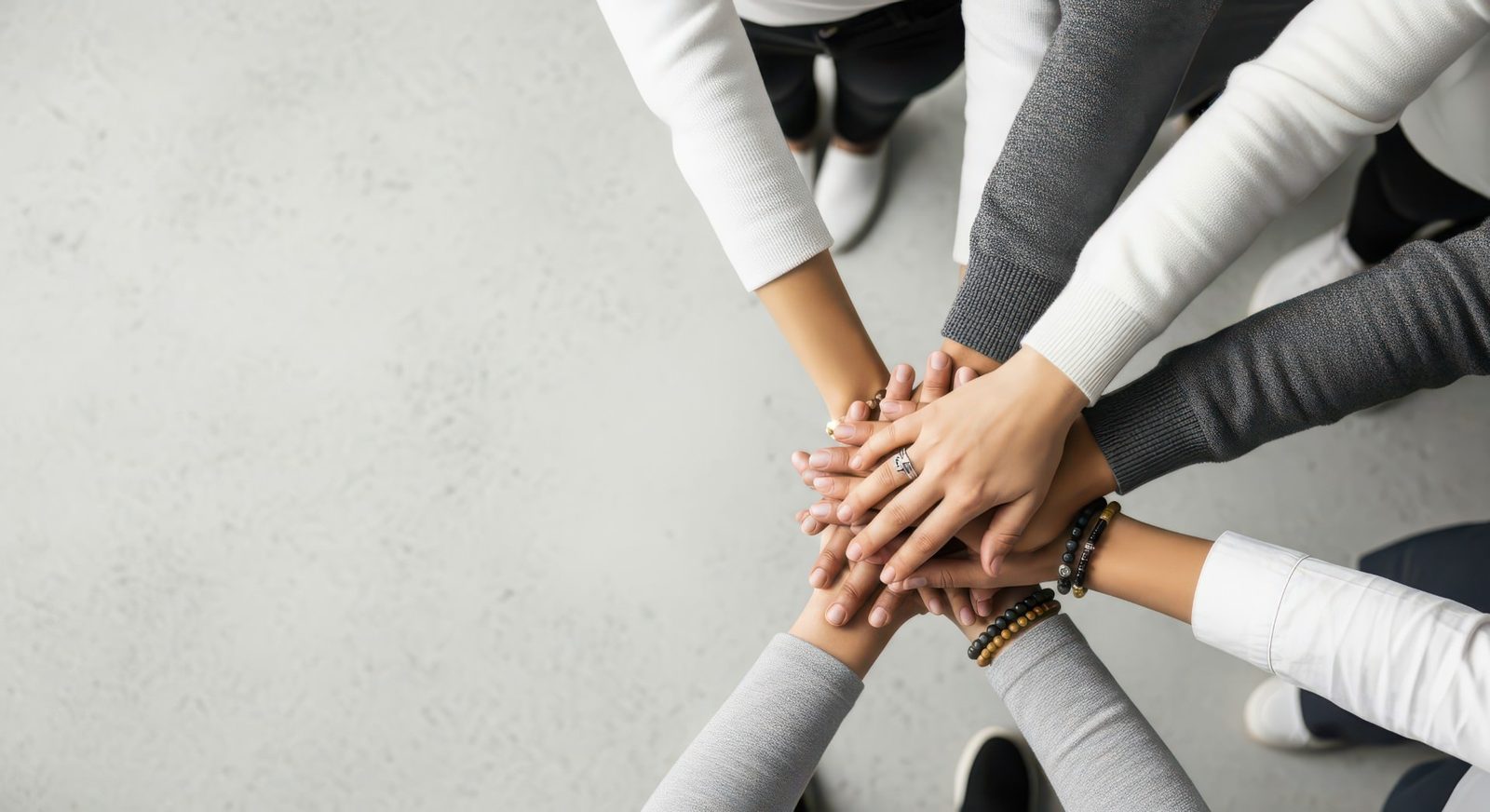 Nonprofit Web Design Team of volunteers stacking their hands together